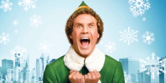 Buddy the Elf smiling on a blue, snowy background of New York City