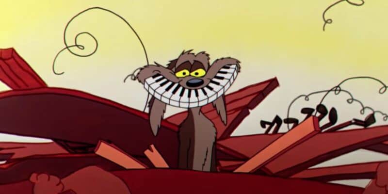 Wile E. Coyote with a piano key smile inside a broken piano