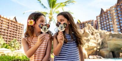 Two girls eating Mickey Mouse ice cream at Disney Resort
