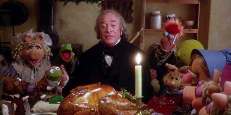 Ebenezer Scrooge eating Christmas dinner with a bunch of Muppets