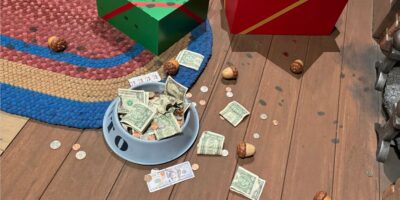 Guests throw money away in the queue for Minnie & Mickey's Runaway Railway.