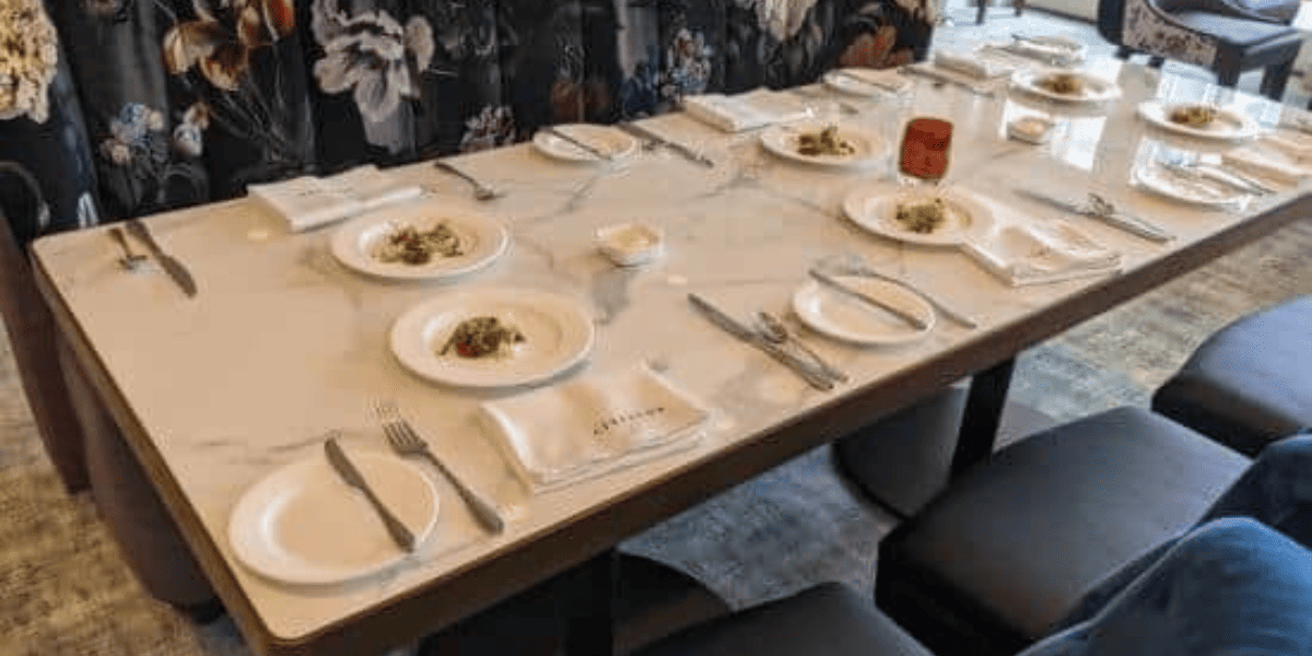 A set table with floral printed benches at Citricos. 