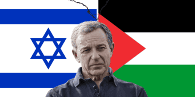 Bob Iger, CEO of Disney, looks seriously in front of the flags of Palestine & Israel.