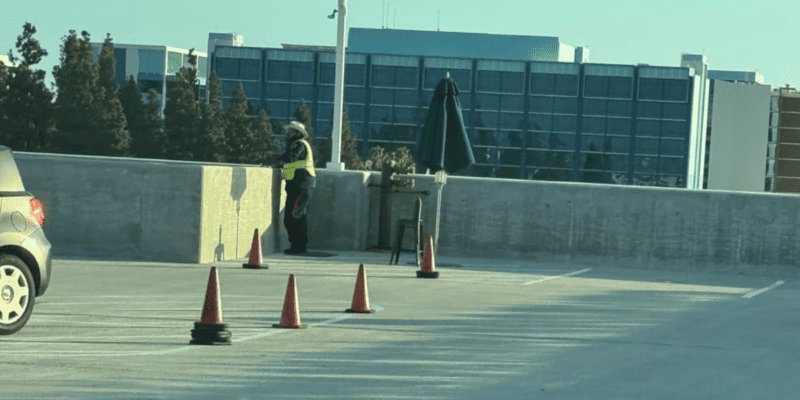 A cast member standing at the top of the Mickey & Friends Parking Structure at Disneyland Resort, where multiple guests have died by suicide.