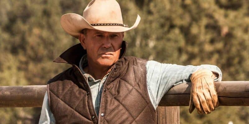 Kevin Costner leaning on a fence in Yellowstone