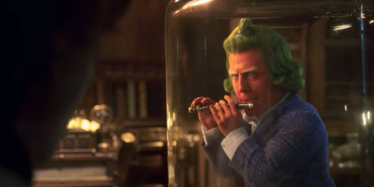 Hugh Grant as an Oompa Loompa playing the flute in 'Wonka'