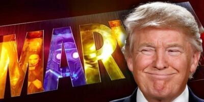 Donald Trump smiling while looking at the Marvel Studios logo.