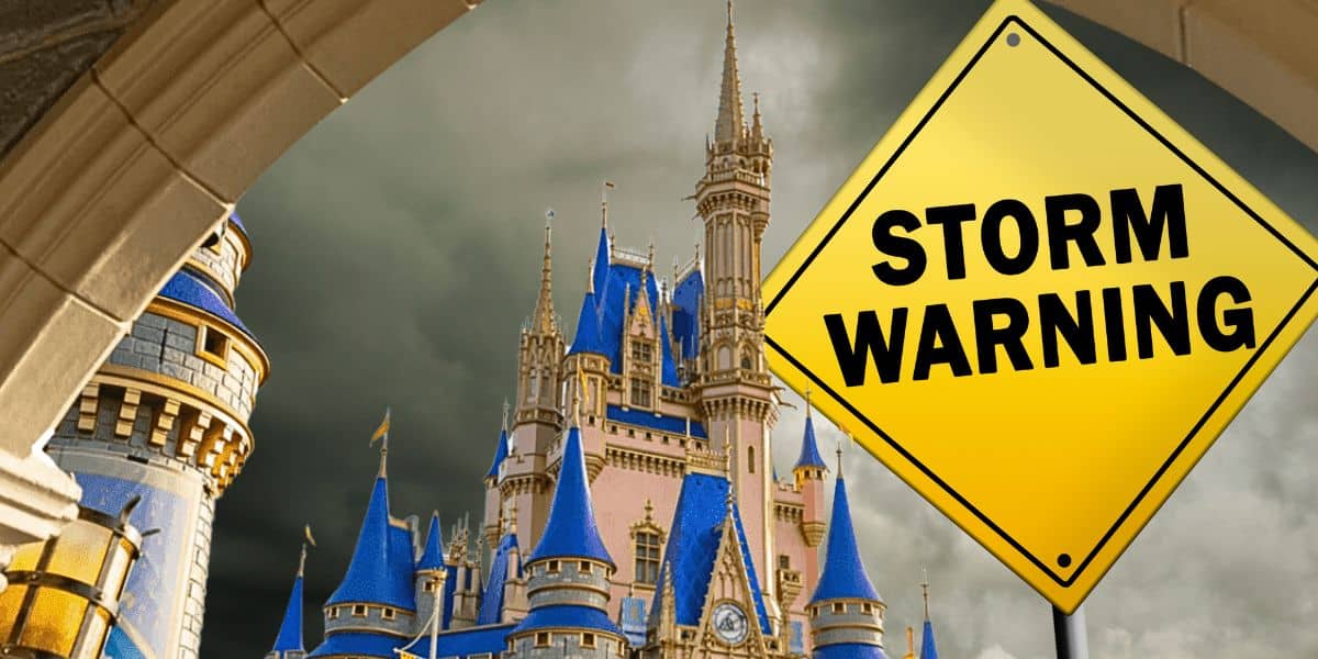 A "storm warning" sign besides the Cinderella Castle inside of Magic Kingdom at Disney World Resort.