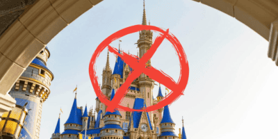 A crossed out circle/boycott symbol over Cinderella Castle at Walt Disney World Resort.
