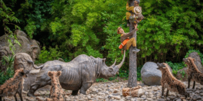 Adventurer figures are terrified on top of a pole, running from a Rhino. This is one of the changes some Disney guests call woke.