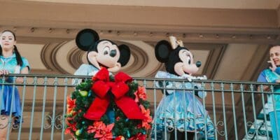 Mickey and Minnie at Magic Kingdom's train station with two dancers