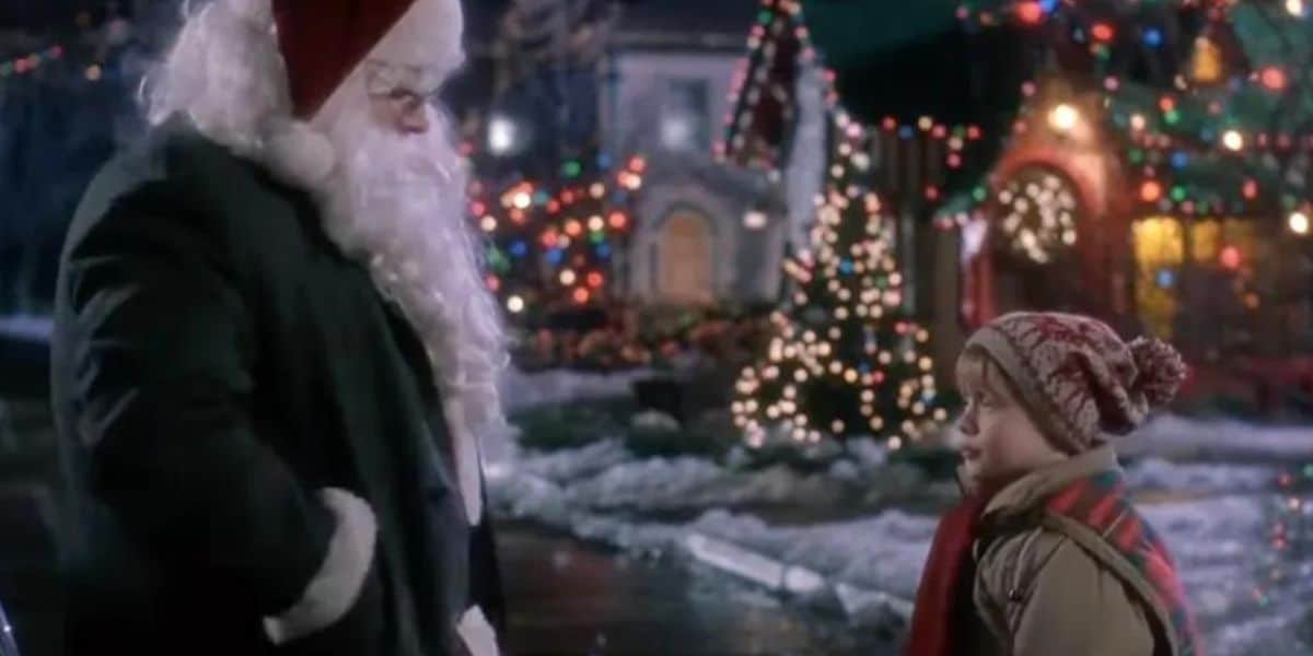 Santa greets a young guest outside on a festive winter night at the park, surrounded by sparkling holiday lights and decorations, evoking the magical spirit of classic Christmas movies.