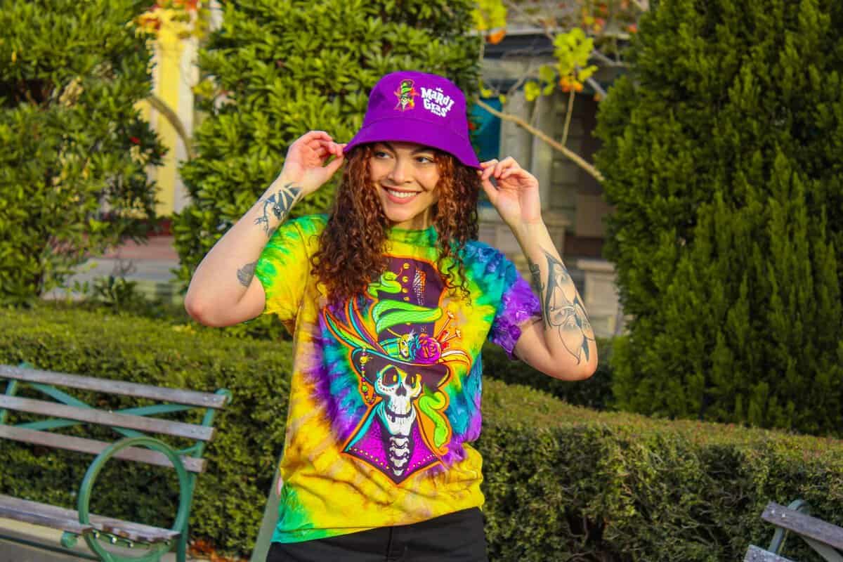 A Universal Orlando Resort guest wearing a Mardi Gras concert tie-dye shirt from the tribute store.