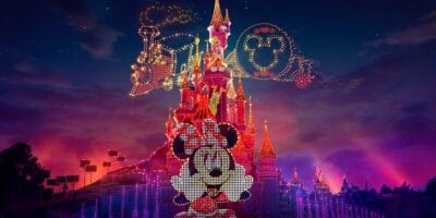 Minnie Mouse on Sleeping Beauty Castle and Casey Jr. in the sky during the Electrical Sky Parade