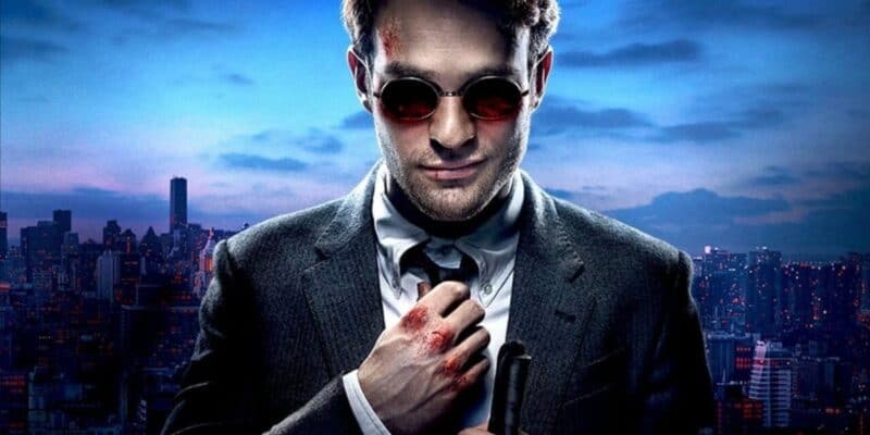 Charlie Cox as Matt Murdock fixing his tie in front of New York City in 'Daredevil'