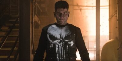 Jon Bernthal as The Punisher in a orange-lit warehouse