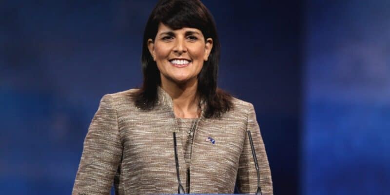 Nikki Haley smiling on a blue background