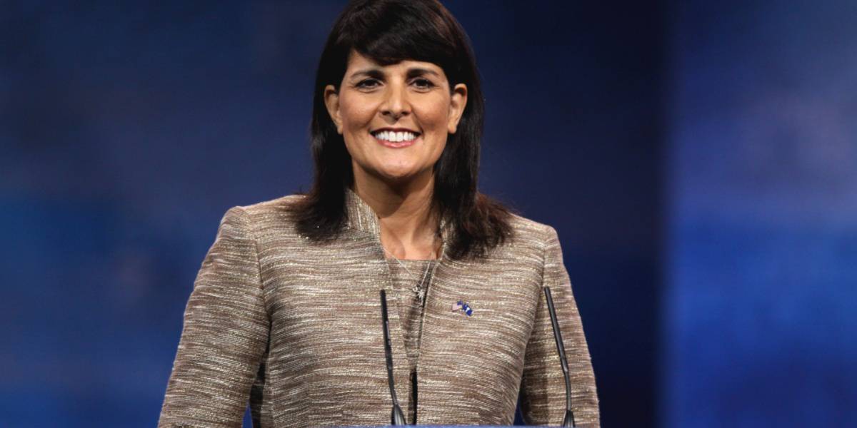 Nikki Haley smiling on a blue background