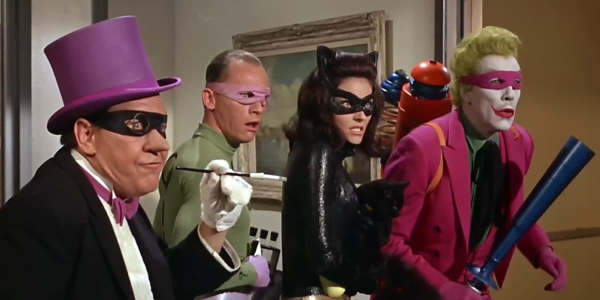 The Penguin, The Riddler, Catwoman, and The Joker looking shocked in masks