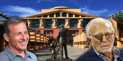 Bob Iger and Nelson Peltz looking at each other in front of the Walt Disney Company building.