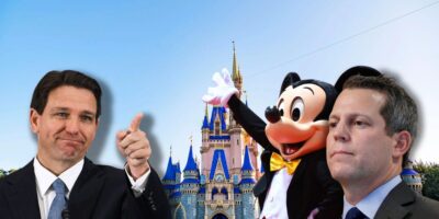 Ron DeSantis pointing towards Mickey Mouse and Andrew Warren inside of Disney World.