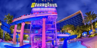 A pool and the monorail with the Disneyland Hotel in the background.