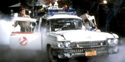 The original Ghostbusters around Ecto-1