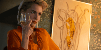 Gillian Anderson as Jean Milburn holding a wine glass in 'Sex Education.'