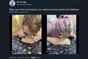 Two people snorting pedialyte on a table at EPCOT.