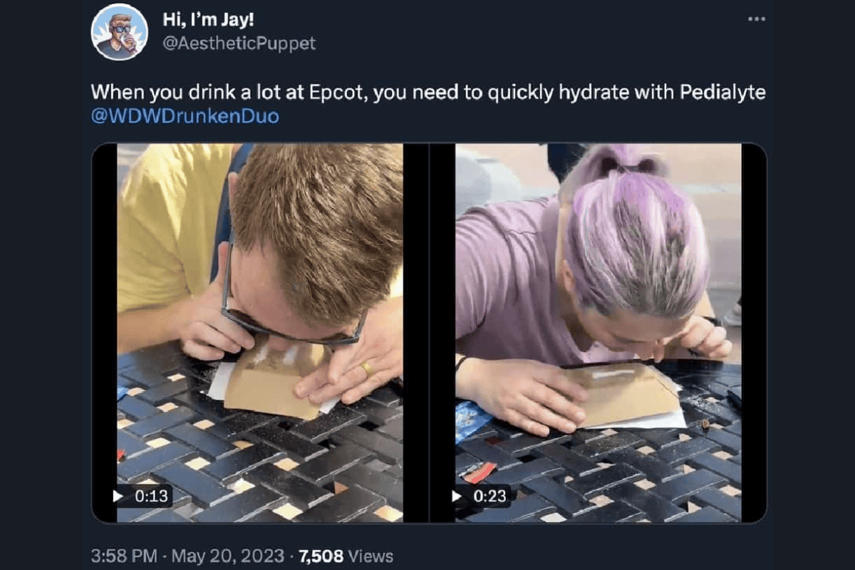 Two people snorting pedialyte on a table at EPCOT. 