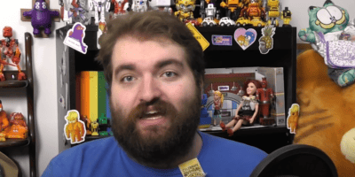 Quinton Kyle Hoover talking in a blue tee shirt for a video on his Youtube Channel, Quinton Reviews.