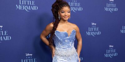 Halle Bailey poses on the blue carpet for Disney's 'The Little Mermaid'