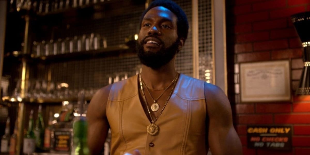 Yahya Abdula-Mateen II behind a bar wearing a leather vest