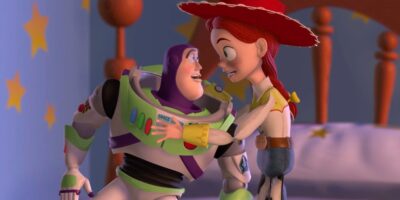 Jessie shaking Buzz Lightyear on a bed