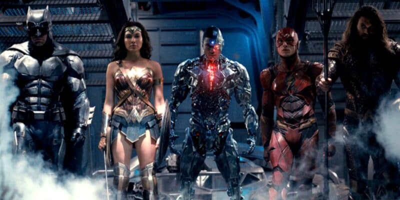 The Justice League standing in a smoky industrial background