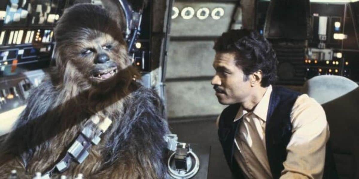 Lando Calrissian wearing Han Solo's clothes talking with Chewbacca in the cockpit of the Millennium Falcon. Still image from 'Star Wars The Empire Strikes Back'