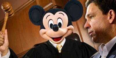 Disney - Florida Governor Ron DeSantis looking angry towards Mickey Mouse dressed as a judge inside of a courtroom.