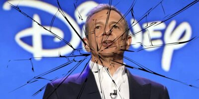Bob Iger against the Disney logo with broken glass overlay