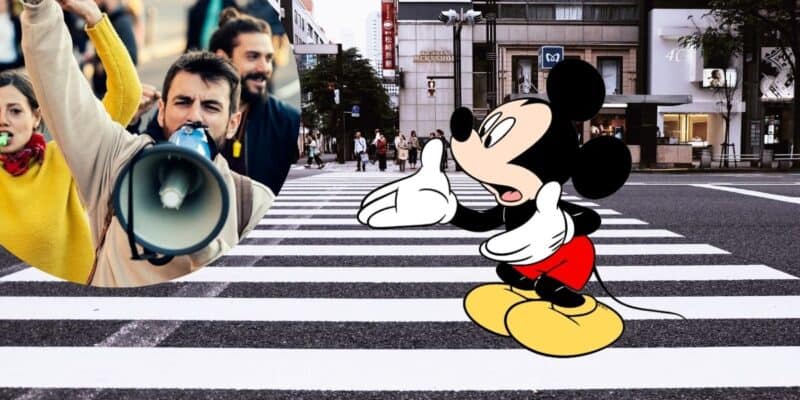 Mickey Mouse with a circle of protestors