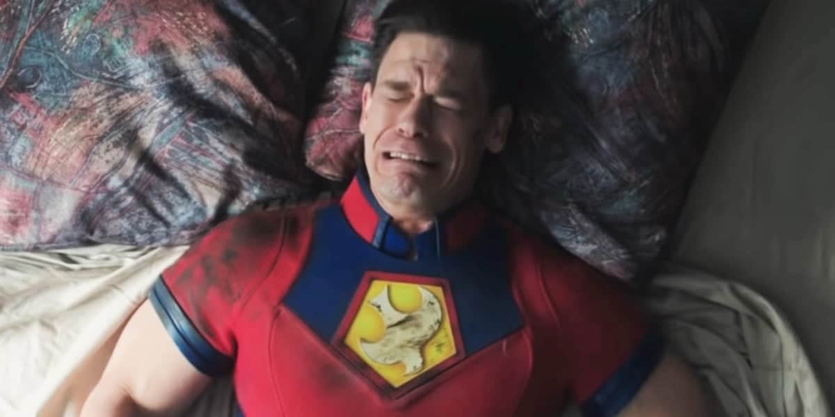 Peacemaker (John Cena) crying on a bed