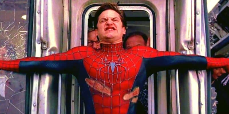 Spider-Man (Tobey Maguire) using webbing and his own body to stop a crashing train