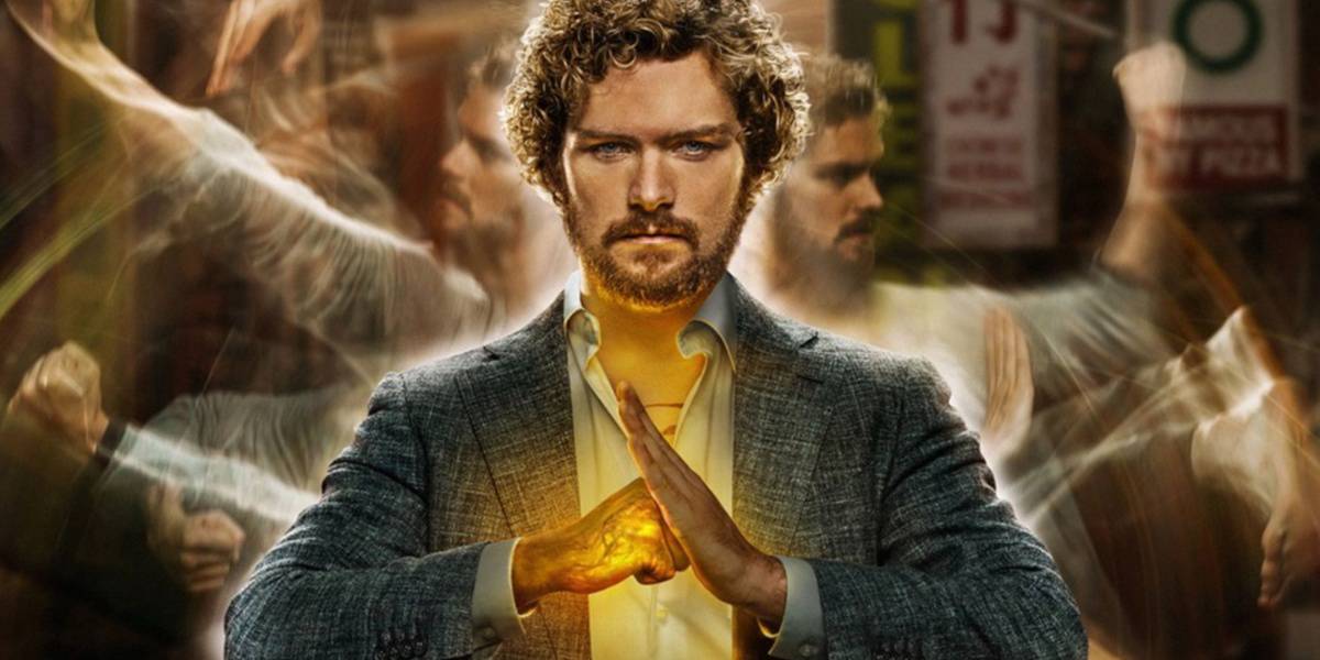 A focused individual surrounded by blurred motion, exuding calm and concentration with glowing hands reminiscent of the Iron Fist, suggesting a moment of supernatural power or intense energy.