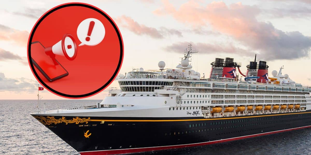 A alert symbol above a Disney Cruise Line ship out in the ocean.