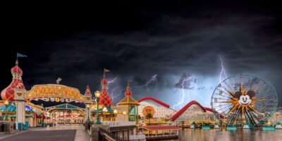 Disneyland Resort in California with a lightning storm in the background.