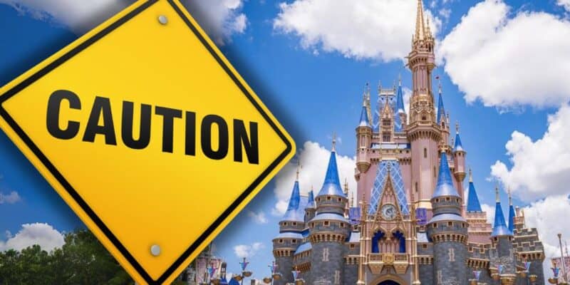 A caution sign next to the Disney World Cinderella Castle in Orlando, Florida.