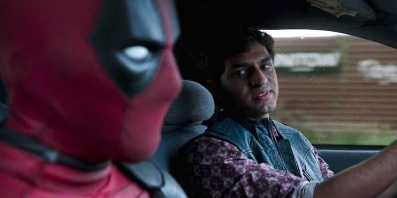 Ryan Reynolds as Deadpool (L) and Karan Soni as Dopinder (R) sat in a taxi