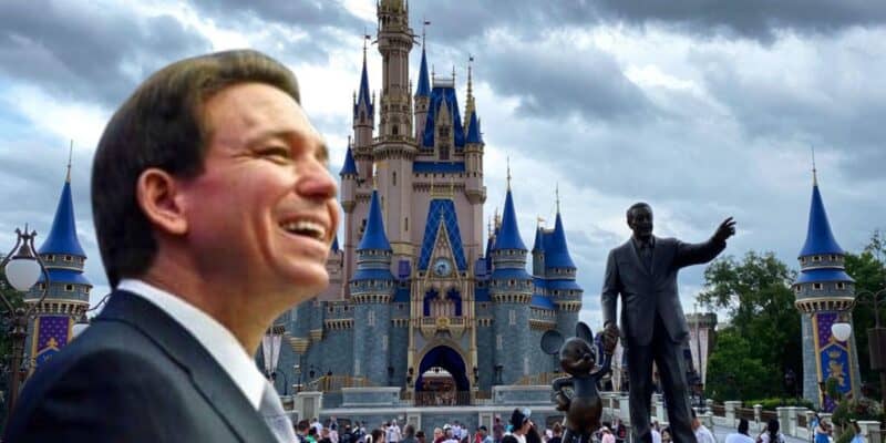 Governor DeSantis smiling broadly with an image of cinderella's castle at walt disney world.