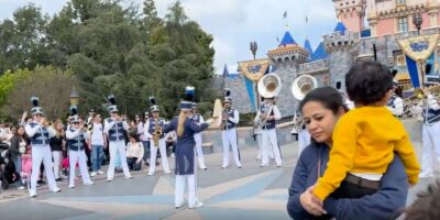 A woman approaches before a fight over a parade spot at Disneyland.