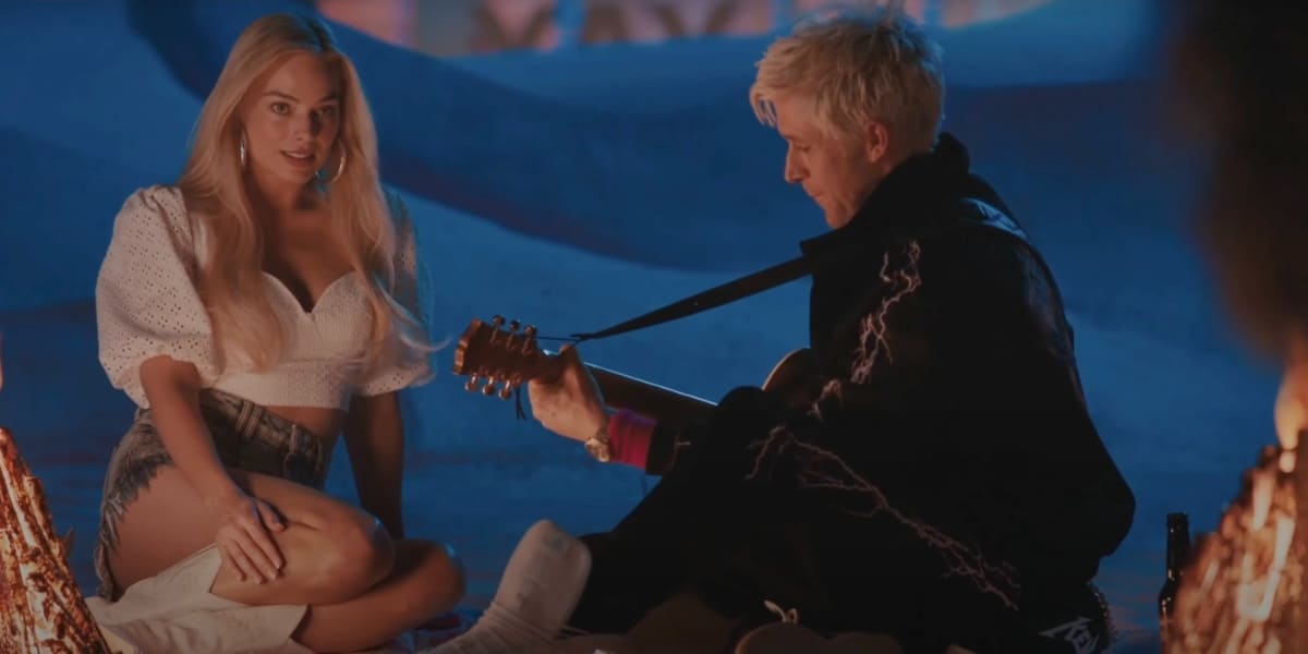 Ken (Ryan Gosling) playing guitar on the beach for Barbie (Margot Robbie)