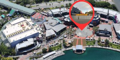 Aerial view of a contemporary waterfront entertainment complex with a close-up insert showing a picturesque sunset at Universal.